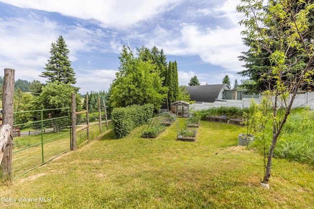 19441 N Rustic Ridge Trl, Rathdrum, ID 83858 - view of yard featuring a vegetable garden and an outdoor structure