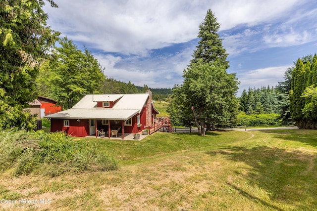 19441 N Rustic Ridge Trl, Rathdrum, ID 83858 - view of grassy yard featuring a patio and a wooded view