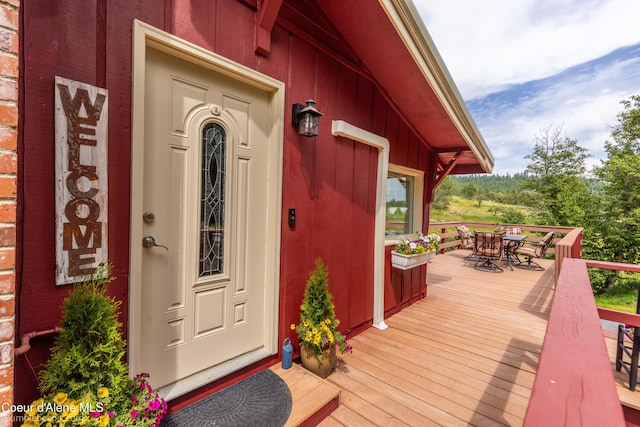 19441 N Rustic Ridge Trl, Rathdrum, ID 83858 - doorway to property with outdoor dining space and board and batten siding