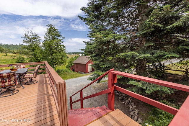 19441 N Rustic Ridge Trl, Rathdrum, ID 83858 - wooden terrace featuring outdoor dining space and an outbuilding