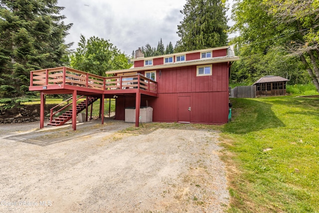 19441 N Rustic Ridge Trl, Rathdrum, ID 83858 - view of front facade with stairs, a wooden deck, and a chimney