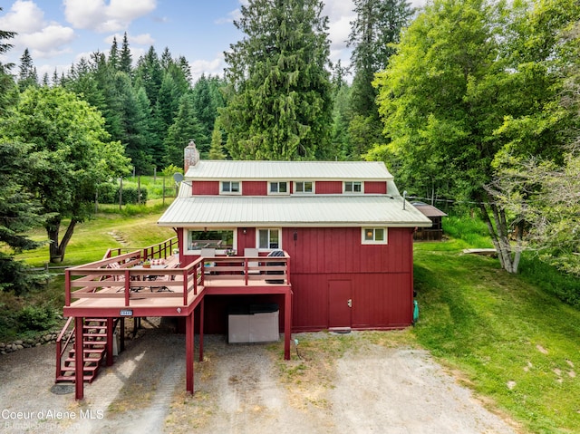 19441 N Rustic Ridge Trl, Rathdrum, ID 83858 - view of front facade featuring stairway, a deck, driveway, a front yard, and a carport