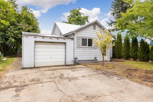 421 W Walnut Ave, Coeur Dalene, ID 83814 - view of front of property with a garage, a metal roof, and driveway