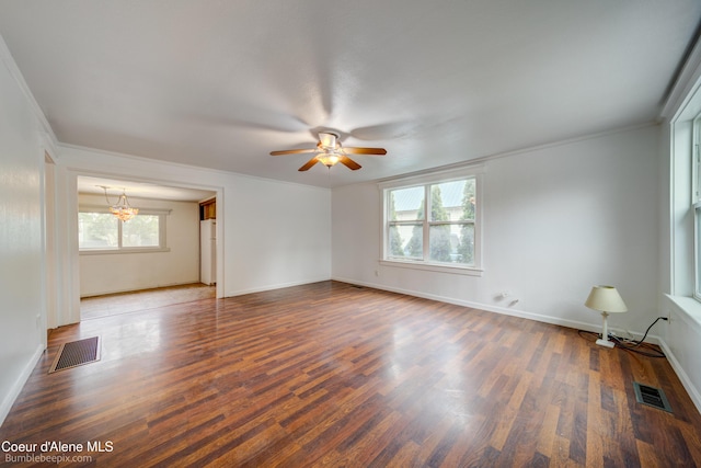 421 W Walnut Ave, Coeur Dalene, ID 83814 - spare room featuring wood finished floors, a ceiling fan, crown molding, and a chandelier