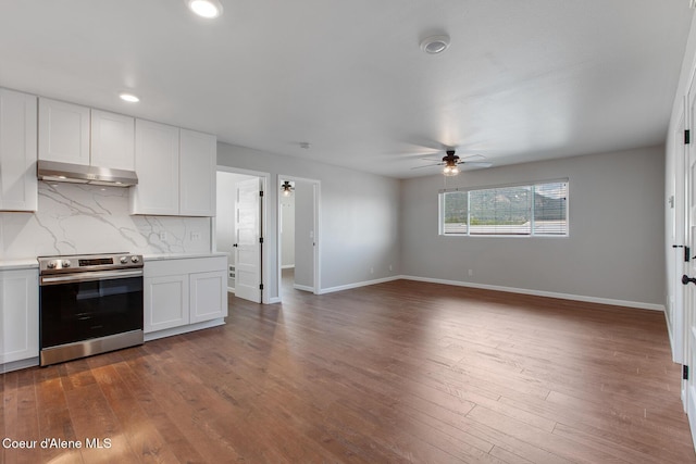 1313 N Division Ave Unit C, Sandpoint, ID 83864 - kitchen with stainless steel range with electric cooktop, under cabinet range hood, ceiling fan, dark wood-type flooring, and recessed lighting