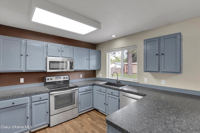 7575 W Crenshaw St, Rathdrum, ID 83858 - kitchen featuring stainless steel appliances, recessed lighting, light wood finished floors, and dark countertops
