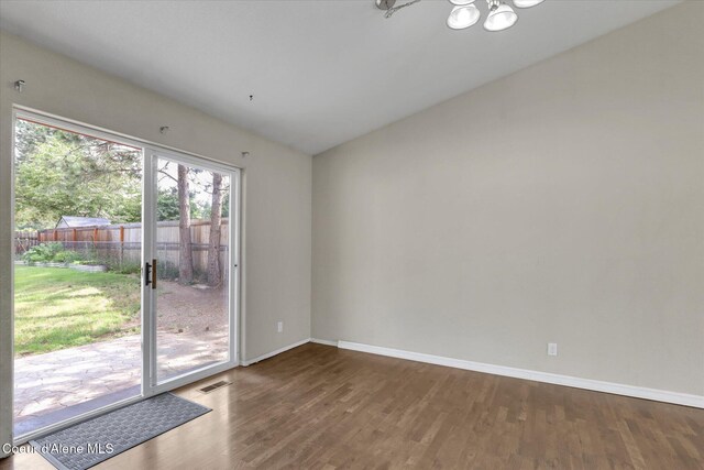 7575 W Crenshaw St, Rathdrum, ID 83858 - unfurnished room featuring a chandelier and wood finished floors