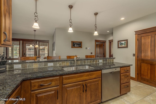 2050 N Main St, Coeur Dalene, ID 83814 - kitchen featuring stainless steel dishwasher, brown cabinets, decorative light fixtures, dark stone counters, and light tile patterned floors