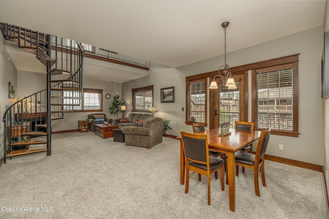 2050 N Main St, Coeur Dalene, ID 83814 - dining space with carpet flooring, stairway, and a chandelier