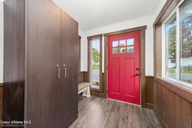 1025 N 1st St, Coeur Dalene, ID 83814 - entryway with healthy amount of natural light, wood finished floors, and wooden walls