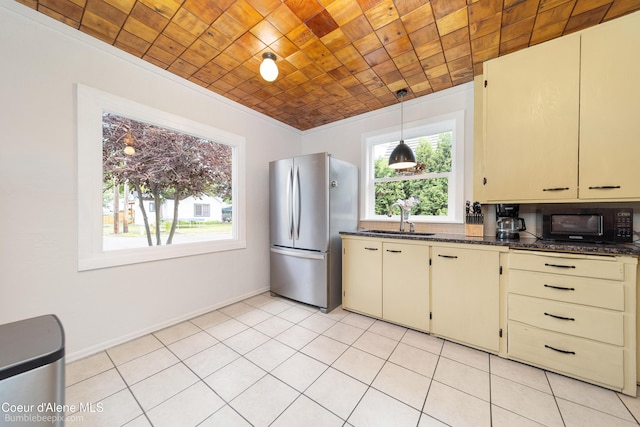 1025 N 1st St, Coeur Dalene, ID 83814 - kitchen featuring freestanding refrigerator, cream cabinets, black microwave, pendant lighting, and wooden ceiling