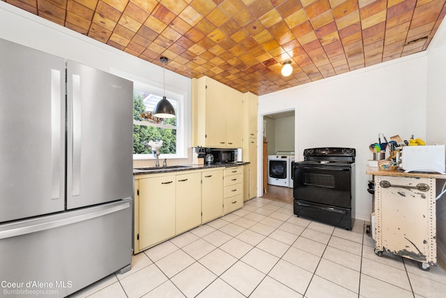 1025 N 1st St, Coeur Dalene, ID 83814 - kitchen featuring black appliances, washer / dryer, cream cabinetry, light tile patterned floors, and dark countertops