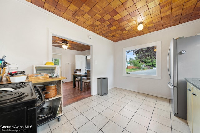 1025 N 1st St, Coeur Dalene, ID 83814 - kitchen with freestanding refrigerator, plenty of natural light, light tile patterned floors, crown molding, and a ceiling fan