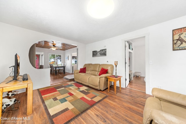 1025 N 1st St, Coeur Dalene, ID 83814 - living room featuring wood finished floors, a ceiling fan, and arched walkways