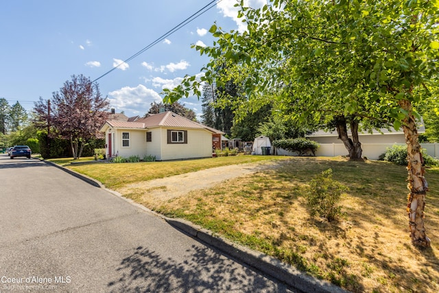 1025 N 1st St, Coeur Dalene, ID 83814 - view of side of home with a storage shed, a metal roof, and driveway