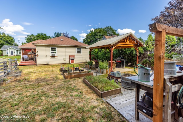 1025 N 1st St, Coeur Dalene, ID 83814 - view of yard featuring a vegetable garden, a gazebo, and a wooden deck