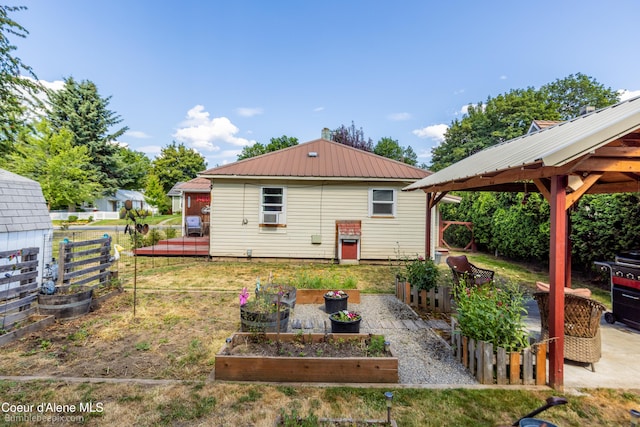 1025 N 1st St, Coeur Dalene, ID 83814 - rear view of property featuring a garden, a gazebo, and a metal roof