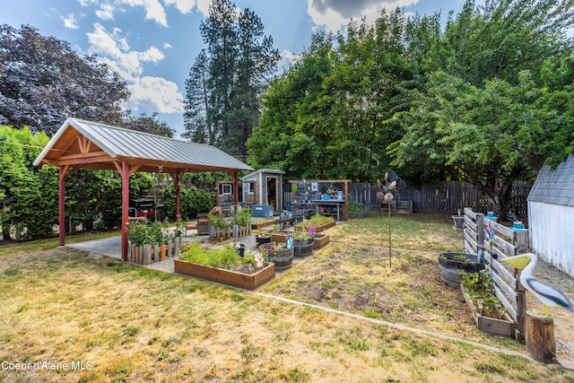 1025 N 1st St, Coeur Dalene, ID 83814 - view of yard with a vegetable garden, a gazebo, a shed, and view of scattered trees