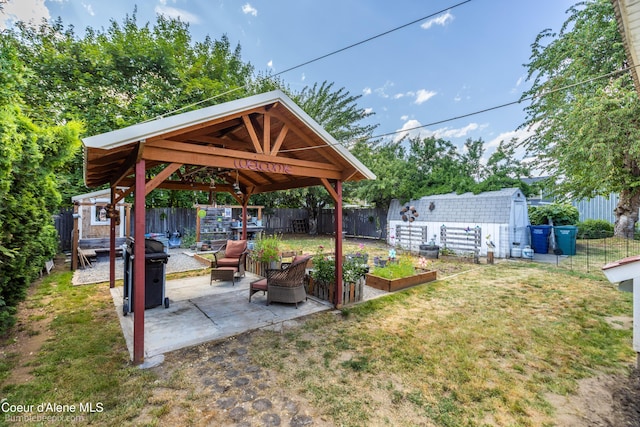 1025 N 1st St, Coeur Dalene, ID 83814 - fenced backyard featuring a shed, a patio, and a vegetable garden