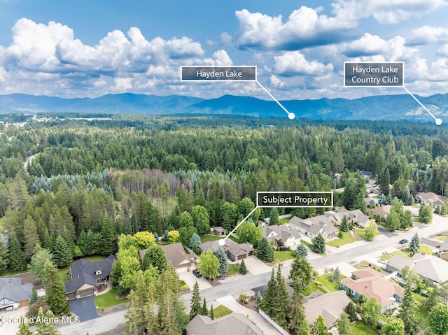 12608 N Shamrock St, Hayden, ID 83835 - aerial perspective of suburban area with mountains and property boundaries highlighted