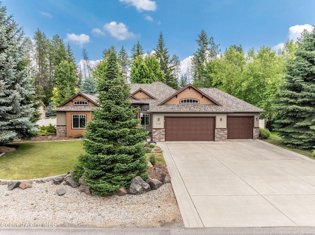 12608 N Shamrock St, Hayden, ID 83835 - ranch-style house with stone siding, an attached garage, concrete driveway, and a front lawn