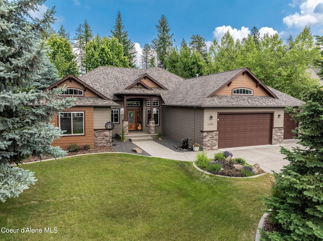 12608 N Shamrock St, Hayden, ID 83835 - view of front of home with an attached garage, driveway, a front yard, and stone siding