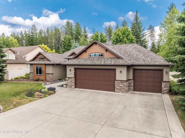 12608 N Shamrock St, Hayden, ID 83835 - view of front of home featuring a garage, concrete driveway, and stone siding