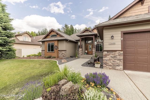 12608 N Shamrock St, Hayden, ID 83835 - craftsman-style home featuring stone siding, a garage, and concrete driveway