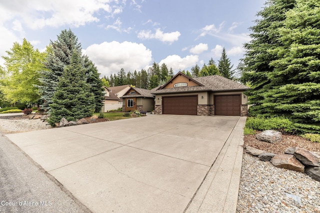 12608 N Shamrock St, Hayden, ID 83835 - view of front of home with a garage, stone siding, and concrete driveway
