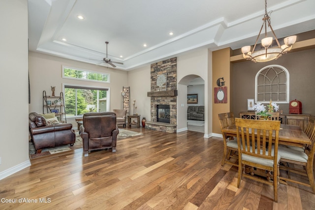 12608 N Shamrock St, Hayden, ID 83835 - dining space featuring a ceiling fan, arched walkways, light wood finished floors, a fireplace, and recessed lighting
