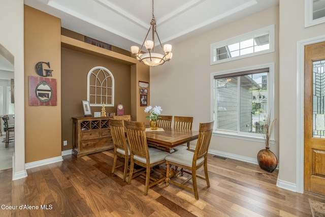 12608 N Shamrock St, Hayden, ID 83835 - dining area with wood finished floors, a chandelier, and a raised ceiling