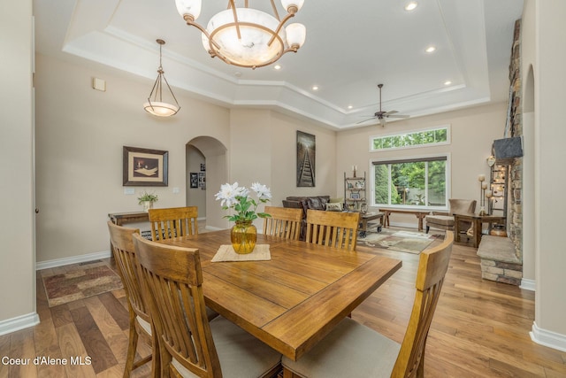 12608 N Shamrock St, Hayden, ID 83835 - dining space with a raised ceiling, arched walkways, ceiling fan, light wood-style flooring, and recessed lighting