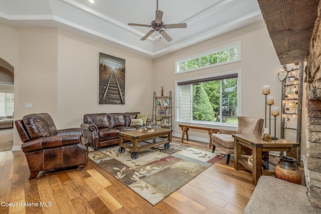 12608 N Shamrock St, Hayden, ID 83835 - living area featuring arched walkways, ceiling fan, light wood-style floors, and a raised ceiling