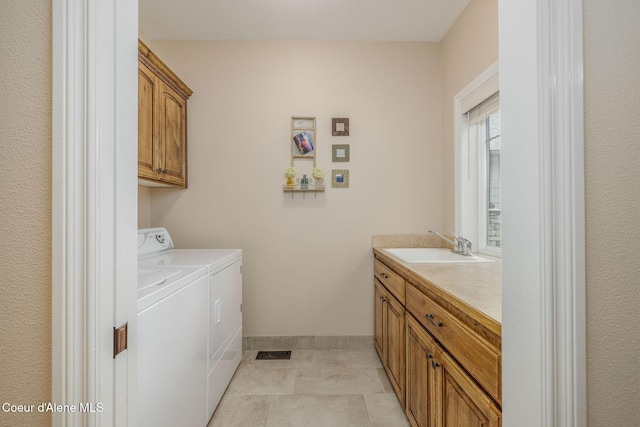 12608 N Shamrock St, Hayden, ID 83835 - washroom featuring washer and dryer, cabinet space, and light tile patterned floors
