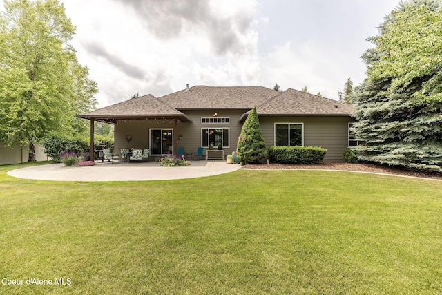 12608 N Shamrock St, Hayden, ID 83835 - back of property featuring a yard, a patio area, and a shingled roof