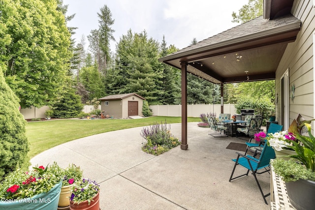 12608 N Shamrock St, Hayden, ID 83835 - fenced backyard with a patio area, a storage unit, outdoor dining space, and grilling area