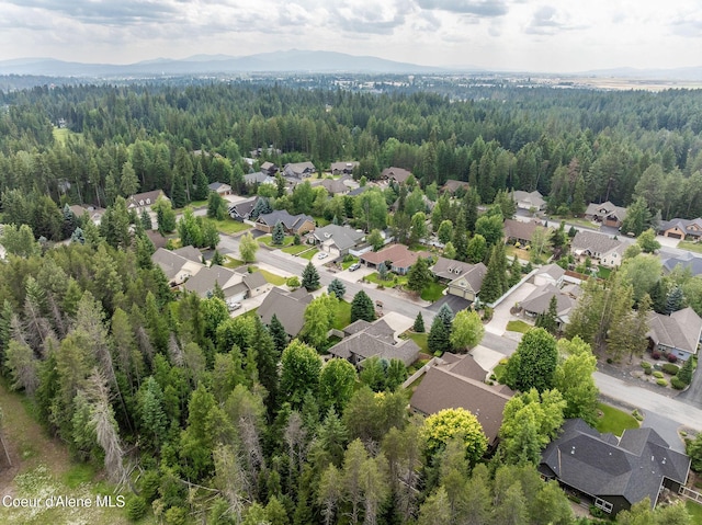 12608 N Shamrock St, Hayden, ID 83835 - aerial view of residential area featuring a heavily wooded area and mountains