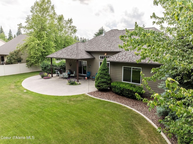 12608 N Shamrock St, Hayden, ID 83835 - back of house featuring roof with shingles and a patio