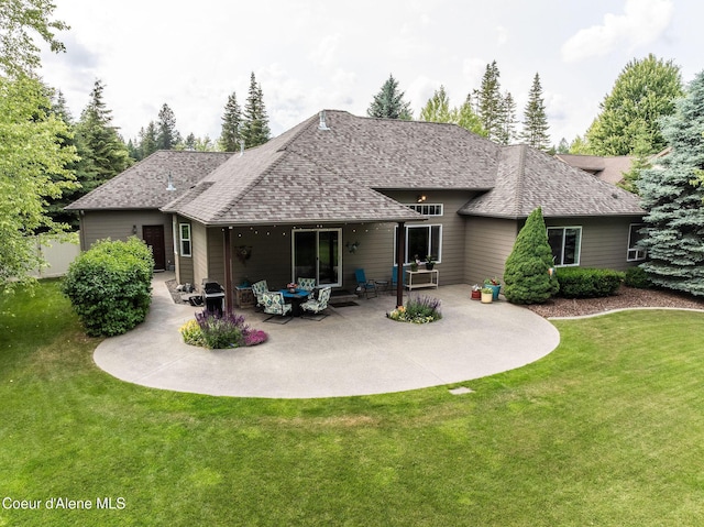 12608 N Shamrock St, Hayden, ID 83835 - rear view of property with a lawn, roof with shingles, and a patio
