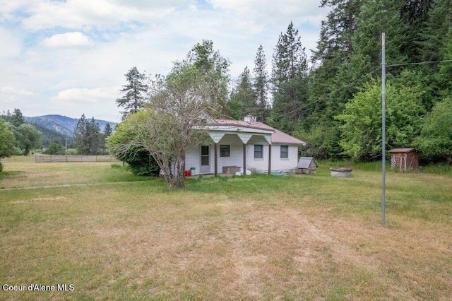1875 S Gateway Ranch Rd, Coeur Dalene, ID 83814 - view of front facade featuring a shed, a mountain view, and a porch