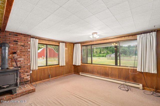 1875 S Gateway Ranch Rd, Coeur Dalene, ID 83814 - unfurnished sunroom featuring a baseboard radiator and a wood stove