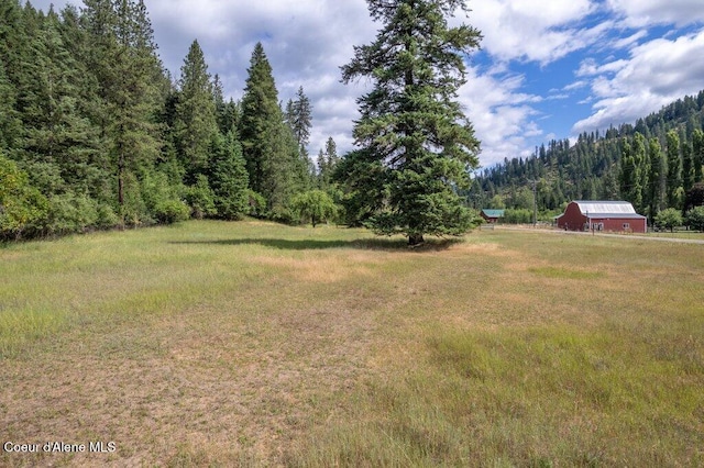 1875 S Gateway Ranch Rd, Coeur Dalene, ID 83814 - view of green lawn with a wooded view and a barn