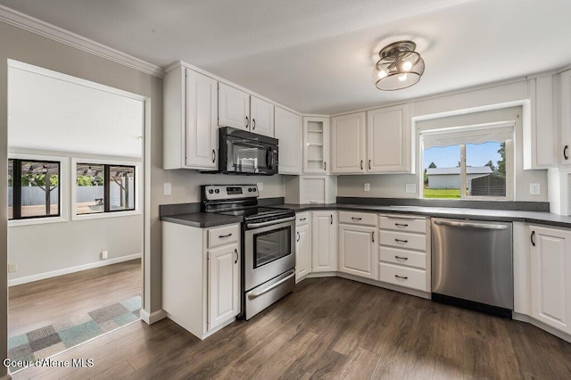 916 E Hanley Ave, Dalton Gardens, ID 83815 - kitchen with appliances with stainless steel finishes, dark countertops, dark wood finished floors, crown molding, and white cabinets