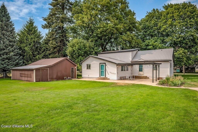 916 E Hanley Ave, Dalton Gardens, ID 83815 - rear view of property featuring a lawn, entry steps, a patio area, and a metal roof