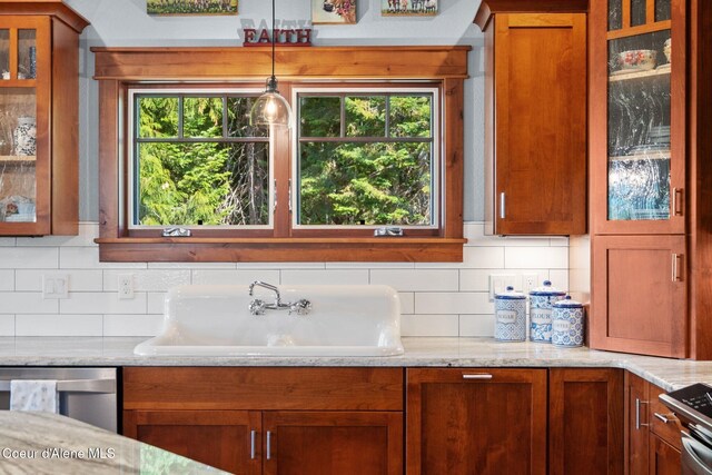4127 Sagle Rd, Sagle, ID 83860 - kitchen with brown cabinetry, decorative backsplash, and dishwasher