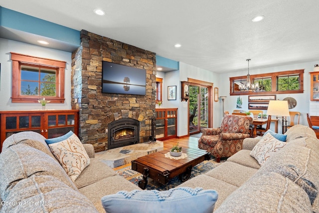 4127 Sagle Rd, Sagle, ID 83860 - living room featuring a chandelier, wood finished floors, recessed lighting, and a stone fireplace