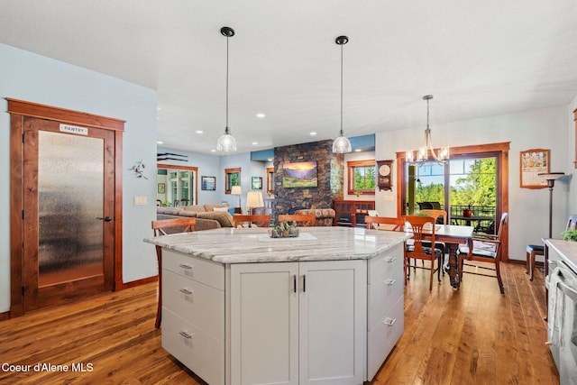 4127 Sagle Rd, Sagle, ID 83860 - kitchen featuring light wood-style floors, a center island, pendant lighting, open floor plan, and recessed lighting