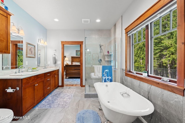 4127 Sagle Rd, Sagle, ID 83860 - bathroom with a freestanding tub, a stall shower, double vanity, marble finish floors, and recessed lighting