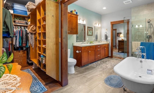 4127 Sagle Rd, Sagle, ID 83860 - full bath with a freestanding bath, double vanity, a shower stall, a walk in closet, and recessed lighting