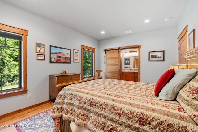 4127 Sagle Rd, Sagle, ID 83860 - bedroom featuring light wood-style flooring, a barn door, and recessed lighting